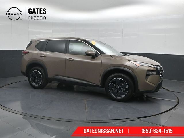 2025 Nissan Rogue SV in Baja Storm Metallic — front three-quarter view
